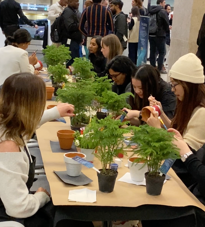 corporate workshops painting clay pots for a seasonal event with employees